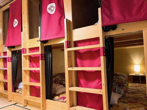 a group of bunk beds in a room at Asama Onsen FAN! MATSUMOTO in Matsumoto