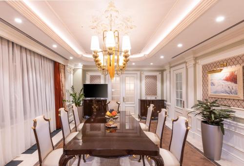 a dining room with a table and a chandelier at Wellness Park Hotel Turon in Samarkand