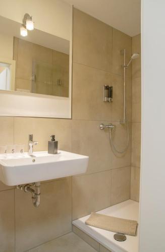 a bathroom with a sink and a shower at B&B Malú am Ring in Müllenbach
