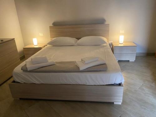 a bedroom with a large bed with two lights on it at b&b Green Valley in Salerno