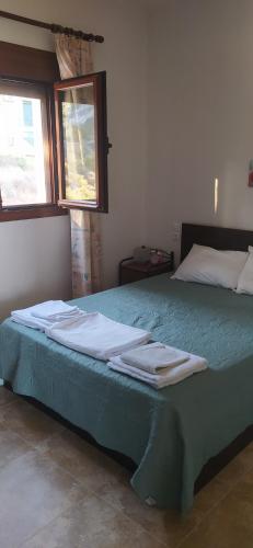 a bedroom with a bed with towels on it at VILLA VASO in Ierapetra