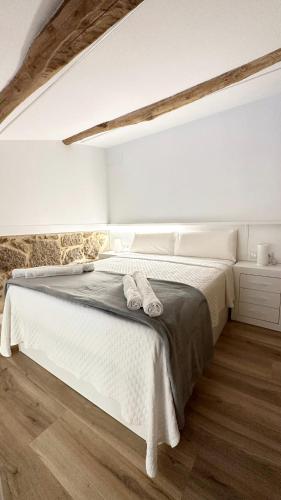 a bedroom with a bed with two towels on it at Celanova House in Celanova