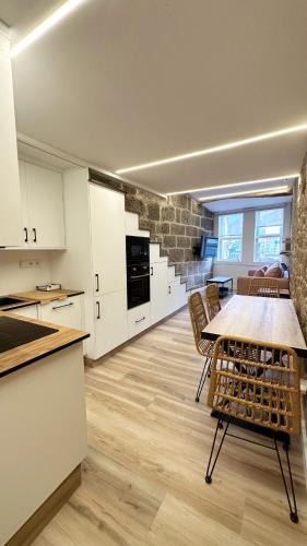 a kitchen and dining room with a table and chairs at Celanova House in Celanova