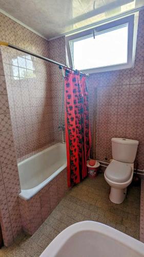 a bathroom with a toilet and a tub and a sink at Kakheti Apartment in Dedoplis Tskaro
