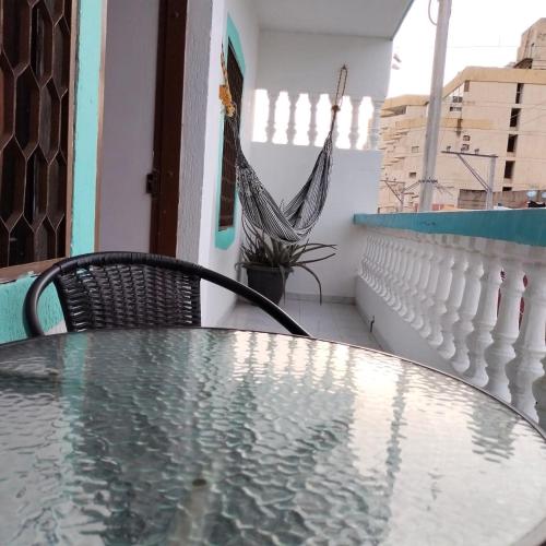 a glass table and a chair on a balcony at Hotel Las Vegas by CMS hotels in Santa Marta