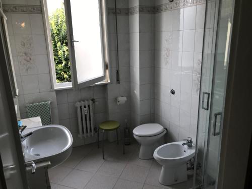 a bathroom with two sinks and a toilet and a window at Maison Lodge in Florence