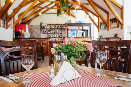 a table with a vase of flowers on a table at Blumenhof Bucovina in Voronet