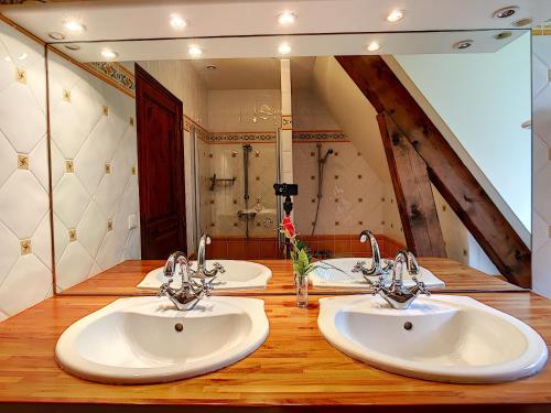a bathroom with three sinks and a large mirror at DomaineRossignol Acacia in Gourdon-en-quercy