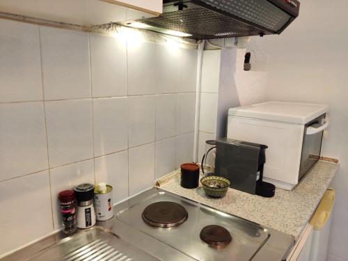 a small kitchen with a stove and a coffee maker at Kyrva Bay Studios in Ierápetra
