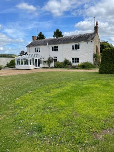 a large white house with a large yard at Ashmore Farm 