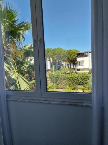 a window with a view of a palm tree at Villa Pearl Adriatic Coast 2 in Golem