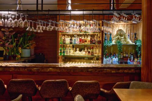 a bar in a restaurant with a lot of bottles at Palmyard Hotel in Manama