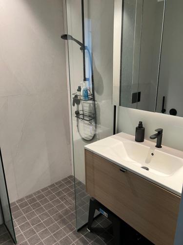 a bathroom with a sink and a shower at Saue Apartment in Haapsalu