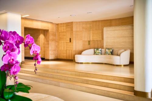 a living room with a couch and a table at Palmyard Hotel in Manama