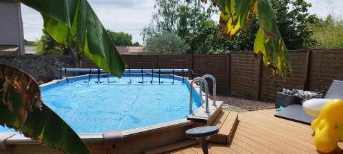 a large swimming pool in a backyard at L escale jardin in Boussay