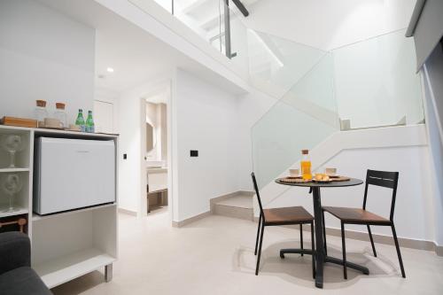 a dining room with a table and two chairs at BET Apartments - Suites Puerto Valencia in Valencia