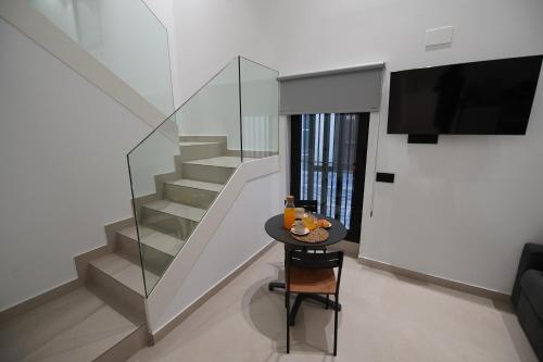 a small table in a room with a staircase at BET Apartments - Suites Puerto Valencia in Valencia