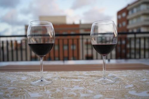 two glasses of red wine sitting on a table at BET Apartments - Suites Puerto Valencia in Valencia