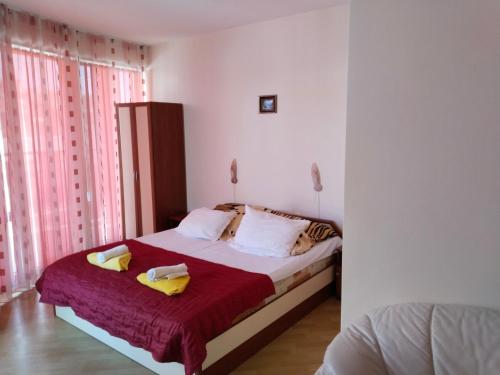 a bedroom with a bed with two towels on it at Apartment Victory Second in Pomorie