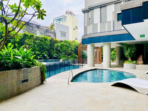 einem Pool vor einem Gebäude in der Unterkunft YuStay Superior Luxury Condotel Central District 1 in Ho-Chi-Minh-Stadt
