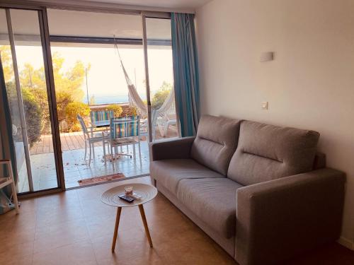 a living room with a couch and a table at Sunny Home Costa Plana-Monaco -Cap D'Ail in Cap d'Ail