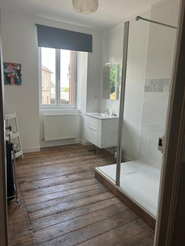 a bathroom with a shower and a sink at Les Ramandes Appartements au cœur du village in Marcillac-la-Croisille