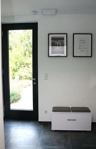 a room with a door and a bench in front of a door at Die Traumhafte - Stilvolle Ferienwohnung mit Komfort in Kleve