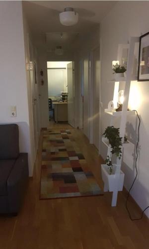 a living room with a couch and a rug on the floor at 12 min from Malmö / Lund in Staffanstorp