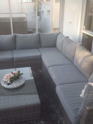 a living room with a couch and a table at 12 min from Malmö / Lund in Staffanstorp