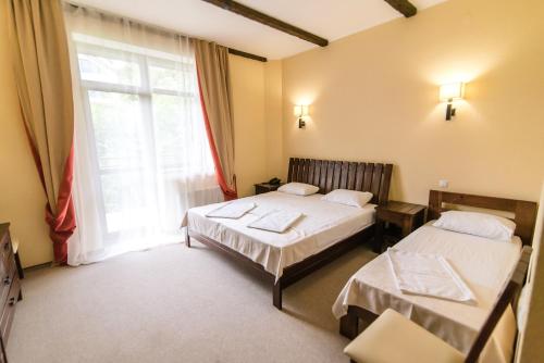 Postel nebo postele na pokoji v ubytování Ruta Resort Polyana