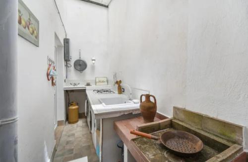 a kitchen with a sink and a counter with a bowl at Casa Cattedrale in Iglesias