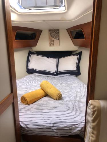 a bedroom with a bed with two towels on it at Casa Veleiro SHALOM in Ponta Delgada