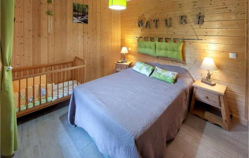 a bedroom with a bed in a wooden cabin at 4 Bedroom Cozy Home In Mont-dore in Le Mont-Dore