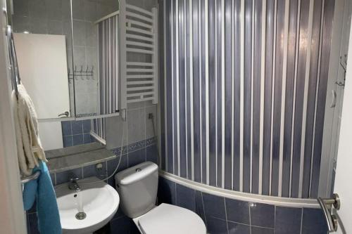 a bathroom with a toilet and a sink and a shower at Exclusive Apartment in Rafailovici
