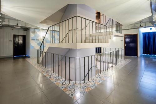 a spiral staircase in a room with a lobby at Montree Phuket Hotel in Phuket Town