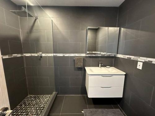 a bathroom with a sink and a mirror at Moden Villa With Amazing Views in Jolly Harbour