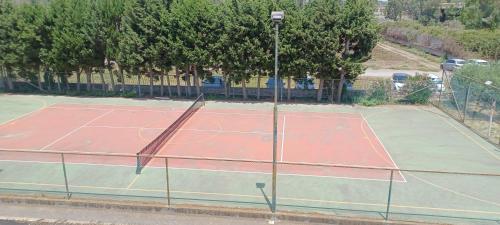 a tennis court with a net on top of it at Casa al mare Sicilia in Fondachello