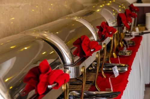 a row of sinks with red poppers on them at Gem Nha Trang Hotel in Nha Trang