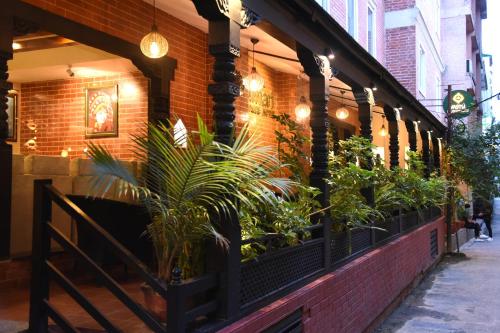 a restaurant with plants on the side of a building at Kumari Boutique Hotel in Kathmandu