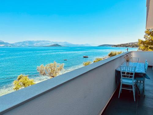 a balcony with a table and chairs and a view of the water at Apartment Rovci 2 in Slatine