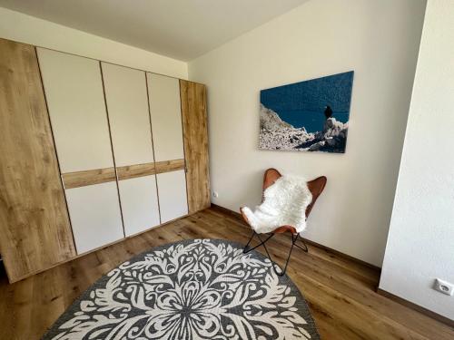 a room with a chair in a room at Ferienwohnung Schwaiger am Königssee in Schönau am Königssee