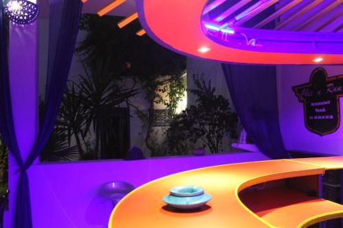 a table in a room with purple lighting at Dar Omar Khayam in Tangier