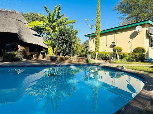 a large swimming pool in front of a house at Birdville BNB Guest House in Gaborone