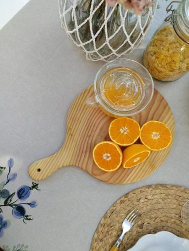 a wooden cutting board with oranges and a bowl of liquid at La Zagala in Badajoz