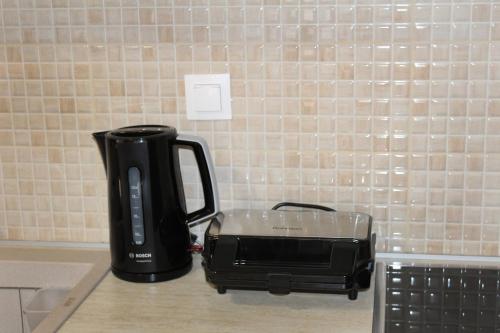 a black appliance sitting on a counter next to a toaster at ZeusPlace Litochoro Central Traditional House in Litochoro