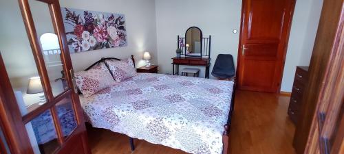 a bedroom with a bed and a dresser and a mirror at ZeusPlace Litochoro Central Traditional House in Litochoro