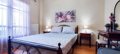 a bedroom with a bed and a desk with two lamps at ZeusPlace Litochoro Central Traditional House in Litochoro