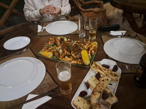 a table with a plate of food on a table at The Tottam Beach Hotel - Trincomalee in Trincomalee