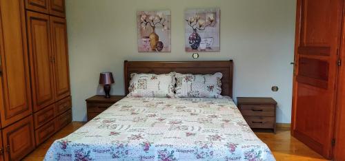 a bedroom with a bed and two pictures on the wall at ZeusPlace Litochoro Central Traditional House in Litochoro