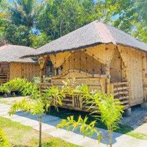 a large bamboo hut with a thatched roof at Casa Gracia's Hotel and Restaurant in San Aquilino